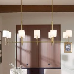 Ali 10-Light Brushed Natural Brass Traditional Dining Room Linear Chandelier with White Fabric Shades by KICHLER -Kichler Sales brushed natural brass kichler chandeliers 52503bnb 76 1000