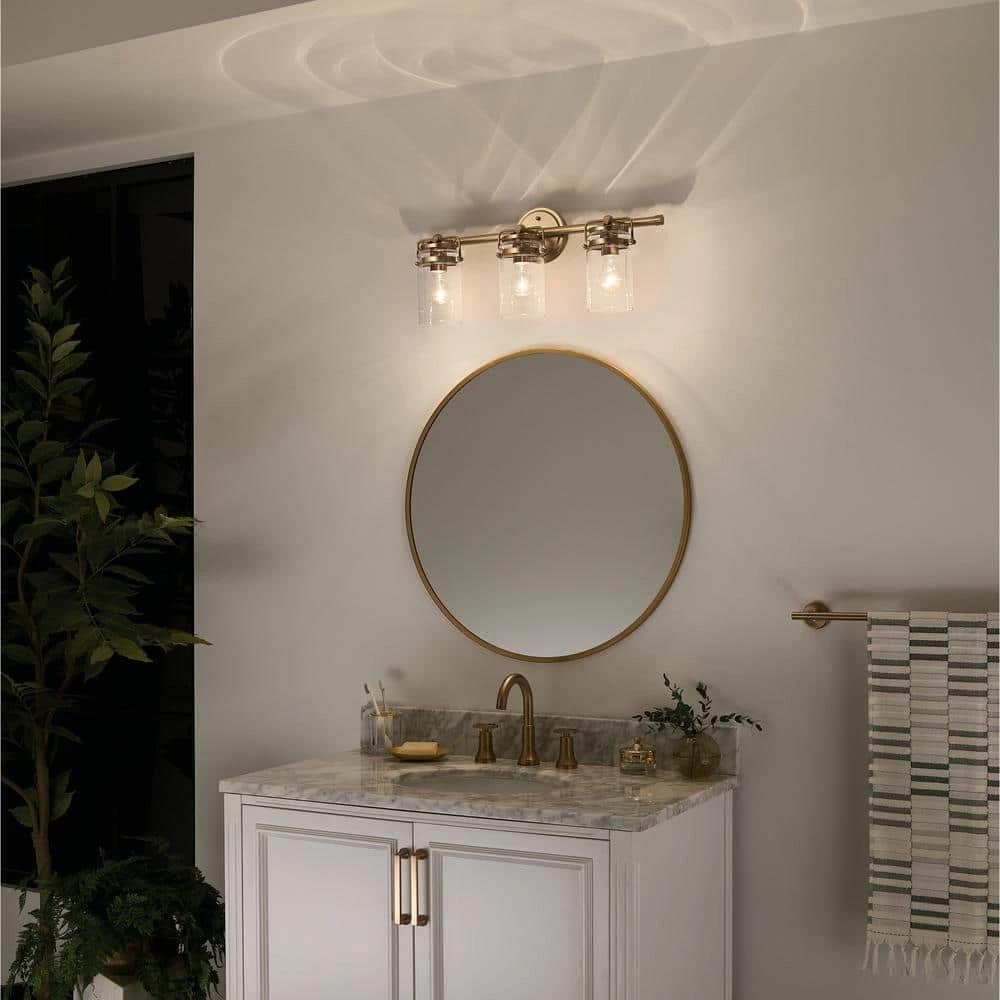 Brinley 24 in. 3-Light Champagne Bronze Bathroom Vanity Light with Clear Glass by KICHLER 9 Brinley 24 in. 3-Light Champagne Bronze Bathroom Vanity Light with Clear Glass by KICHLER - Image 7